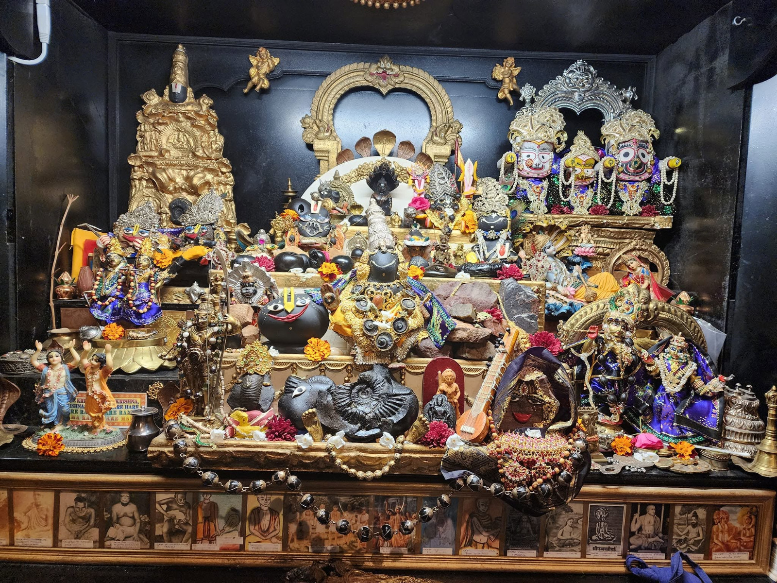 Altar with a large collection of Saligram silas, Jagannath deities and Gaura-Nitai